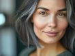 Close-up portrait of a woman with natural grey hair and clear skin, symbolizing the challenge of laser hair removal on grey hair